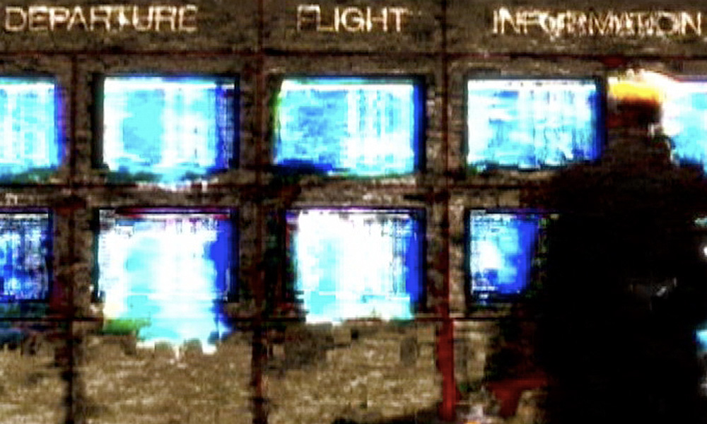 A glitchy bank of monitors.