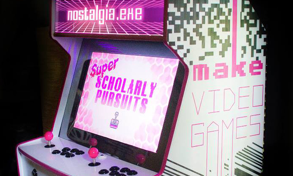 A pink and black themed arcade cabinet that reads SUPER SCHOLARLY PERSUITS side view.